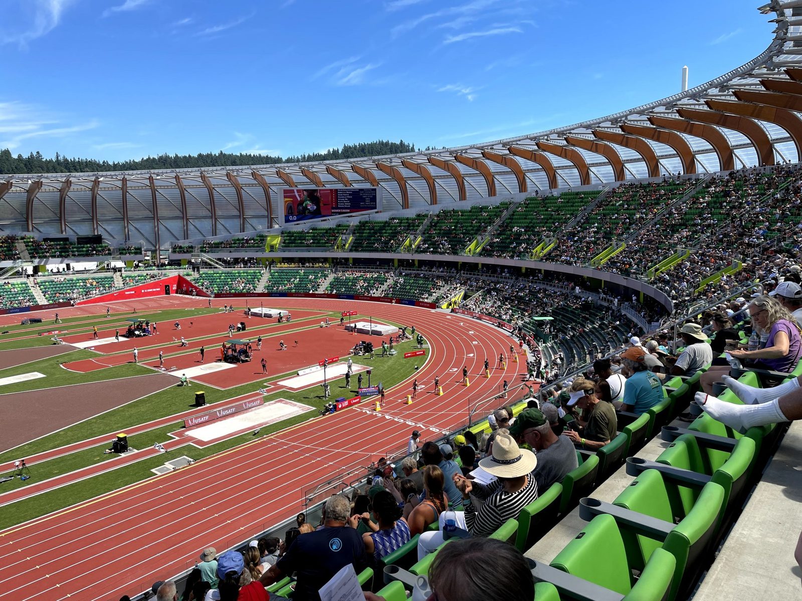 Inside the rebuilt Hayward Field bowl — green seats beneath the arched timber canopy during the 2021 U.S. Olympic Trials