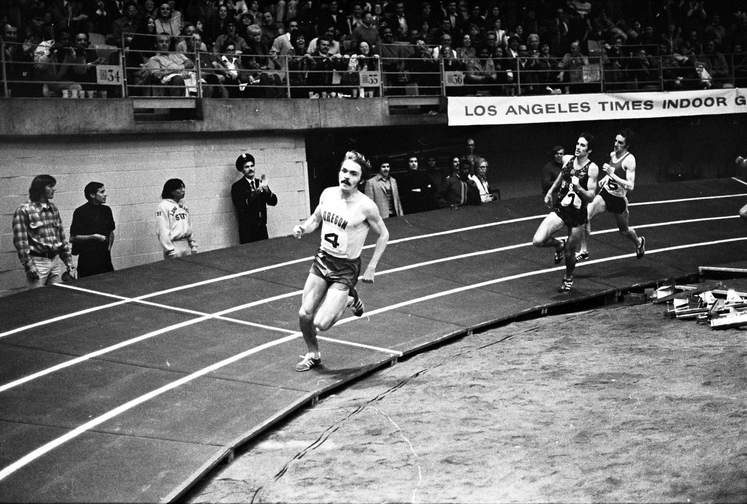 Steve Prefontaine in the Oregon number 4 singlet leading Marty Liquori and Gianni Del Buono in the mile at the 1973 LA Times Indoor Games